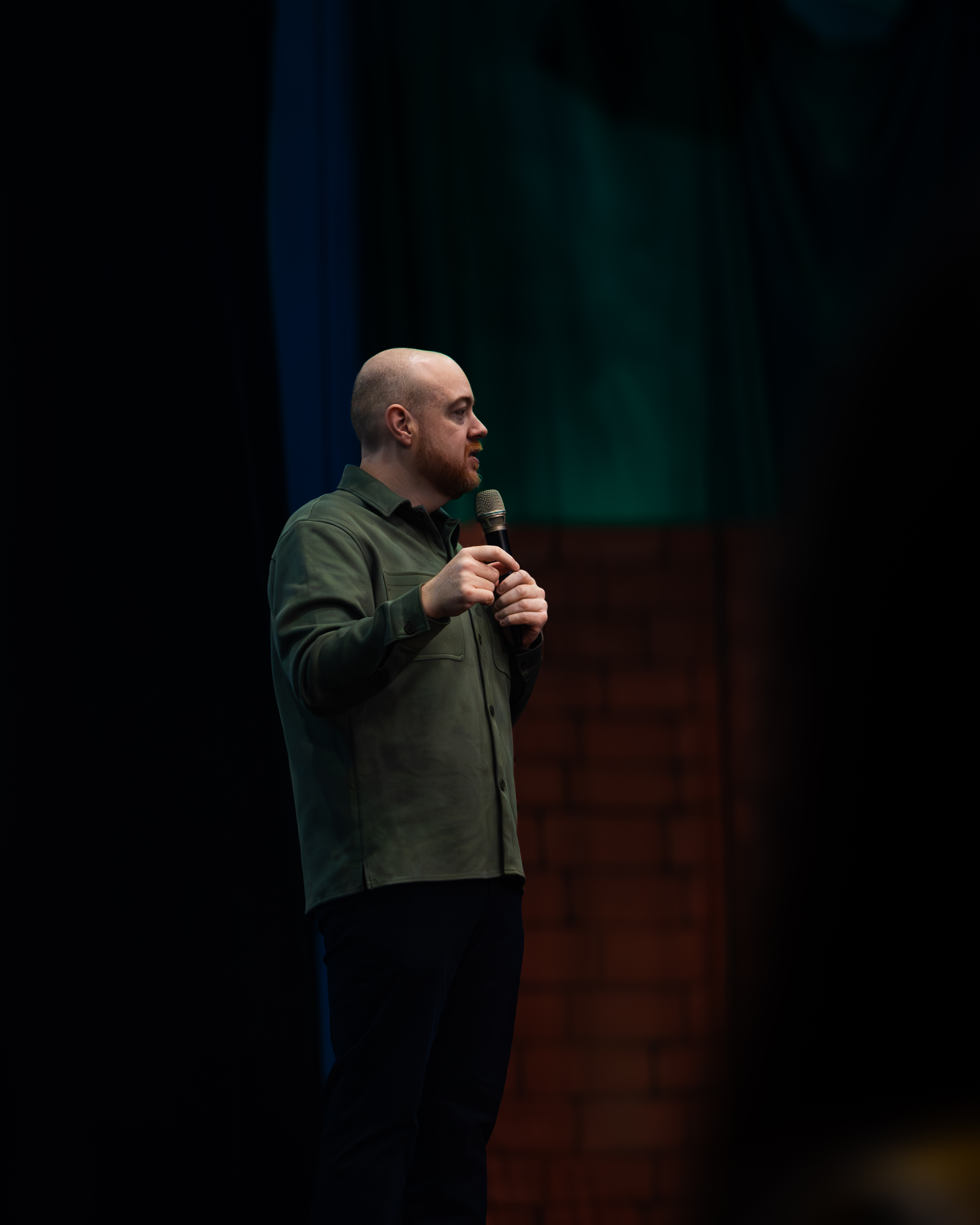 Dan Fitzpatrick speaking in profile on stage