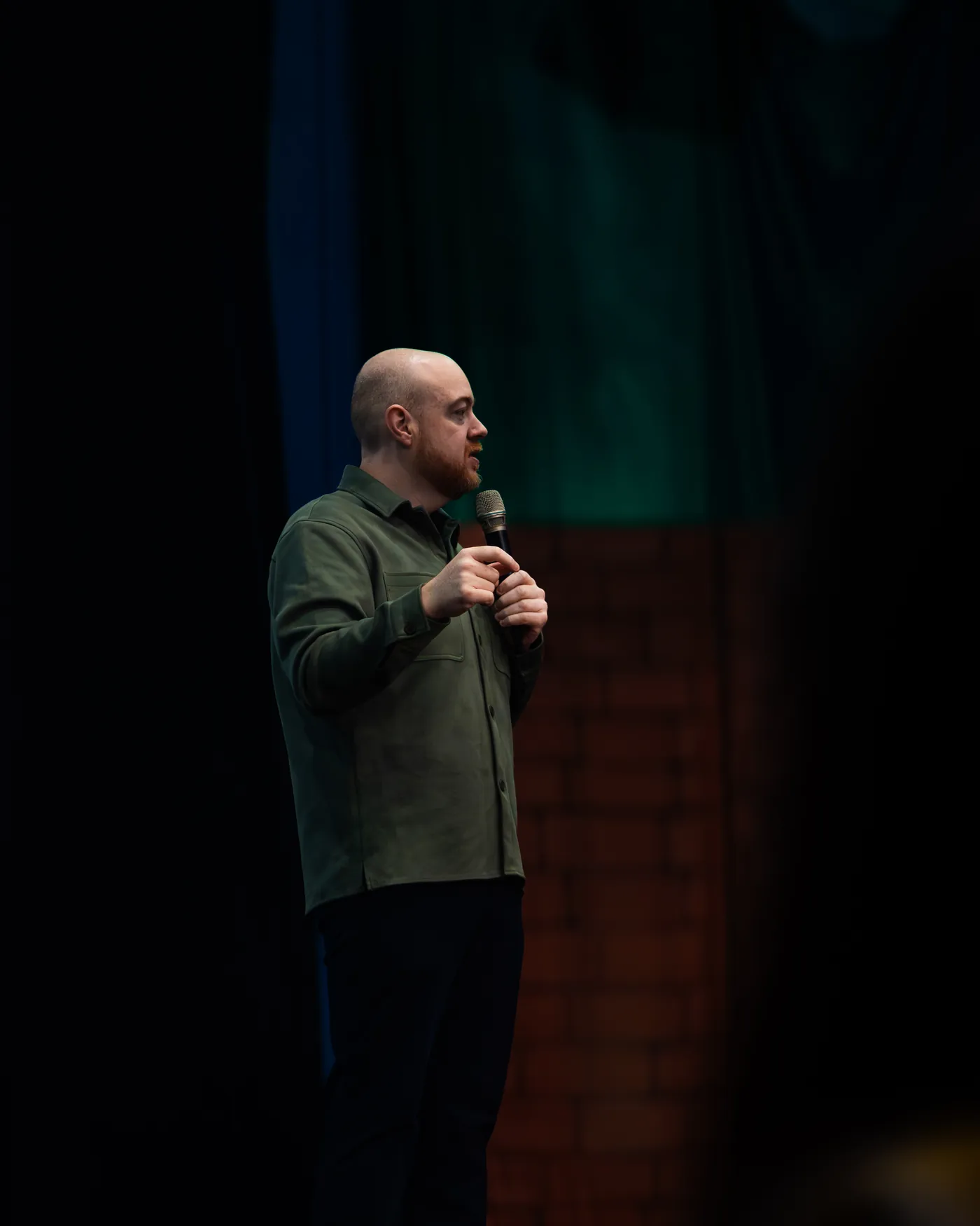 Dan Fitzpatrick speaking in profile on stage